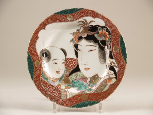 Bord met decor van vrouwenkop en jongetje met perzik, satsuma
